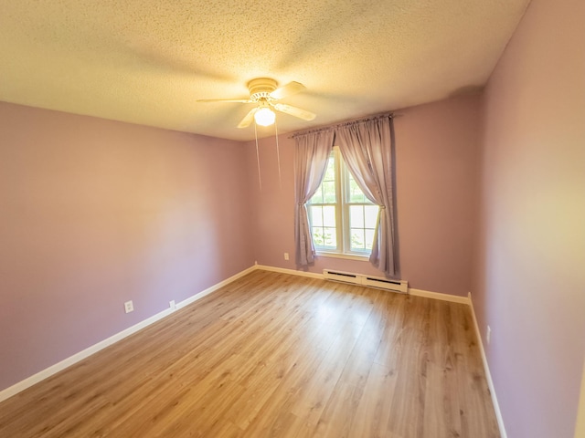 4095 Bell Springs Rd, Marshfield, MO 65706 - empty room with baseboard heating, ceiling fan, light wood-style floors, baseboards, and a textured ceiling