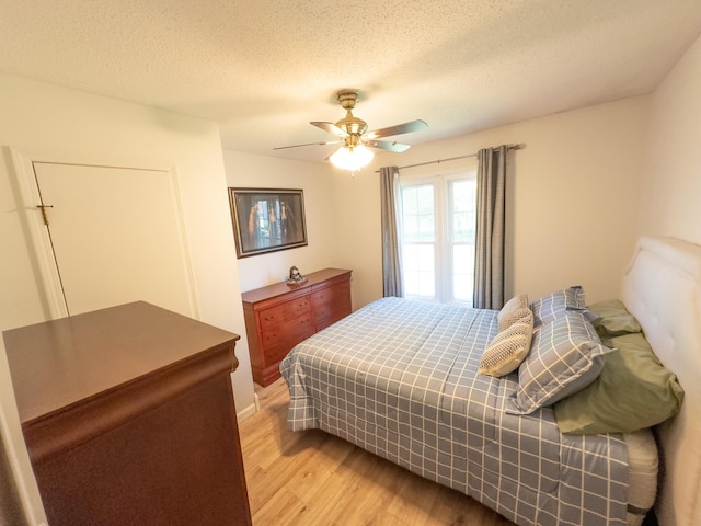 4095 Bell Springs Rd, Marshfield, MO 65706 - bedroom with light wood finished floors, a ceiling fan, and a textured ceiling
