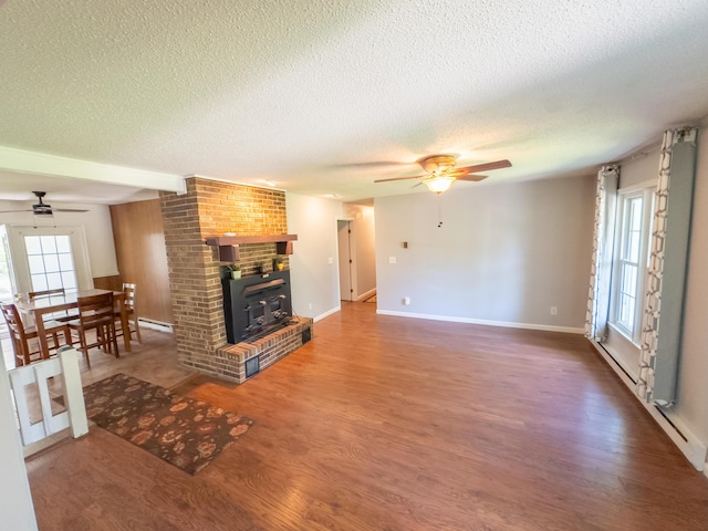 4095 Bell Springs Rd, Marshfield, MO 65706 - unfurnished living room with ceiling fan, a textured ceiling, wood finished floors, a baseboard heating unit, and baseboards