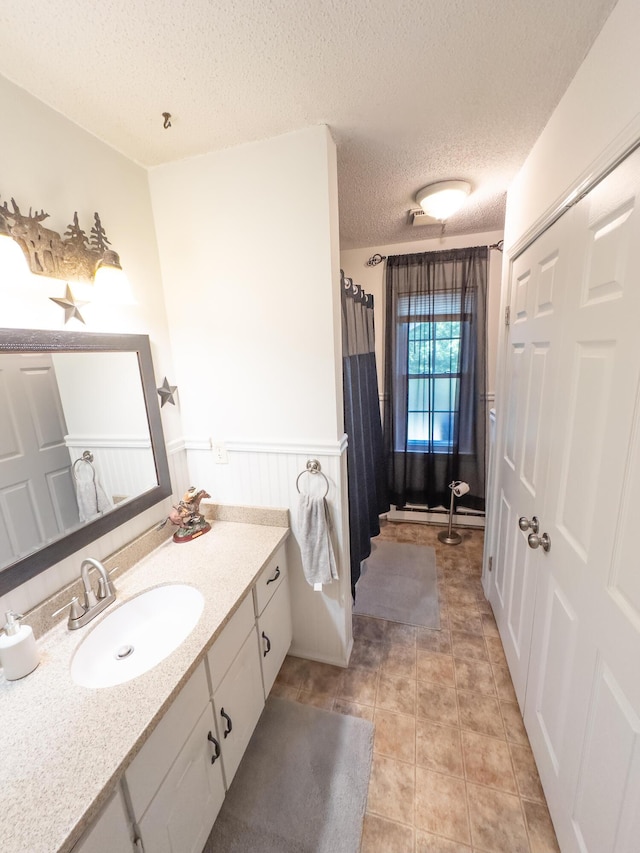 4095 Bell Springs Rd, Marshfield, MO 65706 - full bathroom with a textured ceiling, vanity, wainscoting, a shower with shower curtain, and tile patterned flooring