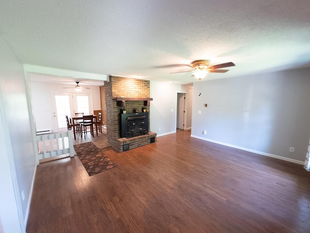 4095 Bell Springs Rd, Marshfield, MO 65706 - unfurnished living room with ceiling fan, a textured ceiling, wood finished floors, and baseboards