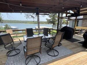21937 Lake Rd Unit M12, Cassville, MO 65625 - wooden terrace featuring a water view and outdoor dining area