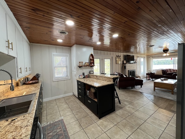 21937 Lake Rd Unit M12, Cassville, MO 65625 - kitchen with wooden ceiling, a fireplace, light tile patterned floors, plenty of natural light, and recessed lighting