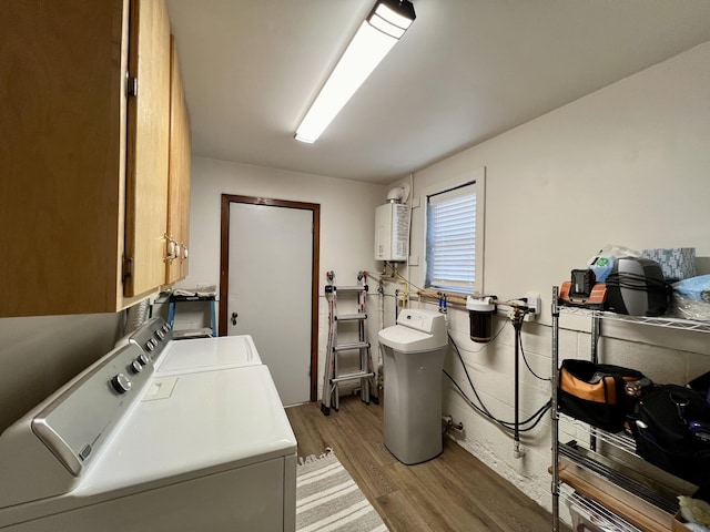 21937 Lake Rd Unit M12, Cassville, MO 65625 - laundry area with washer and clothes dryer, cabinet space, light wood-style flooring, and water heater
