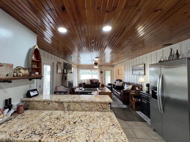 21937 Lake Rd Unit M12, Cassville, MO 65625 - kitchen with stainless steel refrigerator with ice dispenser, wood ceiling, a peninsula, light tile patterned flooring, and open shelves