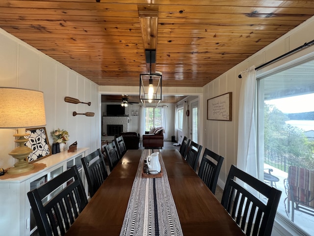 21937 Lake Rd Unit M12, Cassville, MO 65625 - dining area featuring wood ceiling, a fireplace, and a decorative wall