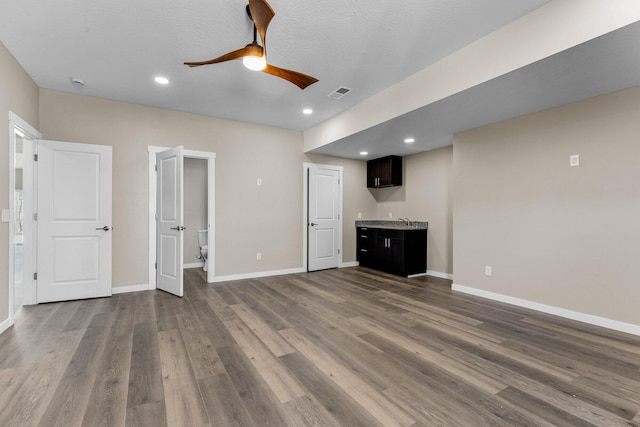 1186 Emory Creek Blvd, Branson, MO 65616 - unfurnished living room featuring a ceiling fan, bar with sink, dark wood-style floors, baseboards, and recessed lighting