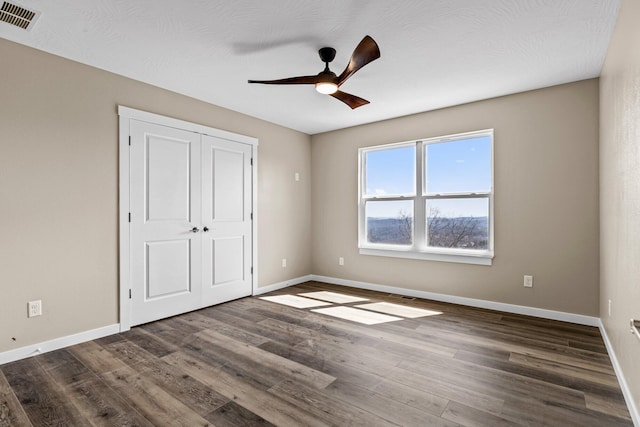 1186 Emory Creek Blvd, Branson, MO 65616 - unfurnished bedroom with baseboards, dark wood finished floors, a closet, and ceiling fan