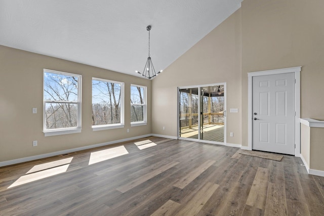 1186 Emory Creek Blvd, Branson, MO 65616 - unfurnished dining area with a chandelier, high vaulted ceiling, baseboards, and wood finished floors