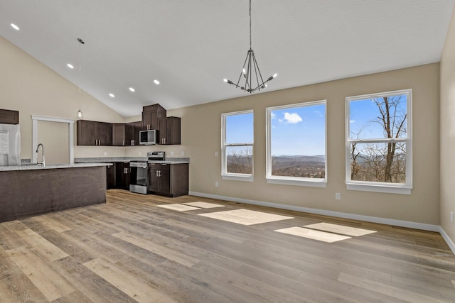 1186 Emory Creek Blvd, Branson, MO 65616 - kitchen with appliances with stainless steel finishes, dark brown cabinets, light countertops, recessed lighting, and light wood finished floors