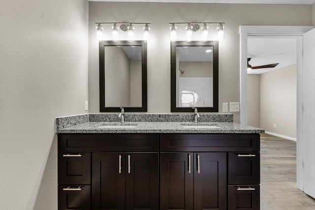 1186 Emory Creek Blvd, Branson, MO 65616 - bathroom with double vanity, a ceiling fan, wood finished floors, and baseboards