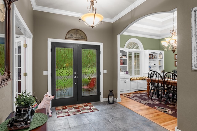 4266 S 94th Rd, Bolivar, MO 65613 - entryway with french doors, crown molding, a chandelier, and arched walkways