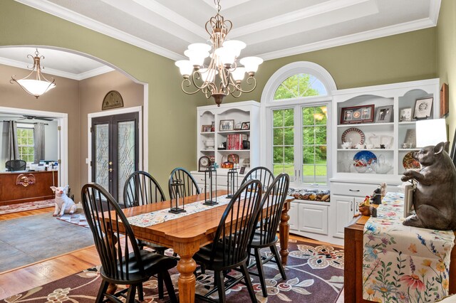 4266 S 94th Rd, Bolivar, MO 65613 - dining area with arched walkways, crown molding, light wood-style flooring, and a chandelier