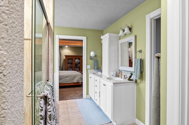 4266 S 94th Rd, Bolivar, MO 65613 - bathroom featuring double vanity, ensuite bathroom, tile patterned flooring, and a textured ceiling