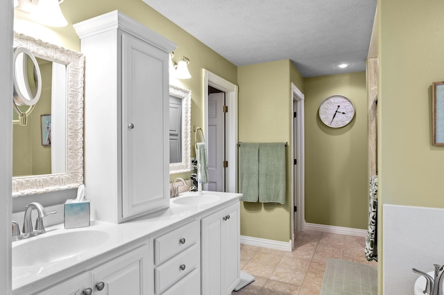 4266 S 94th Rd, Bolivar, MO 65613 - full bath featuring double vanity, a textured ceiling, baseboards, and tile patterned floors