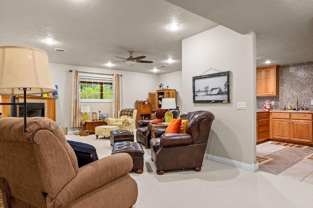 4266 S 94th Rd, Bolivar, MO 65613 - living area with ceiling fan, recessed lighting, a textured ceiling, a tile fireplace, and baseboards