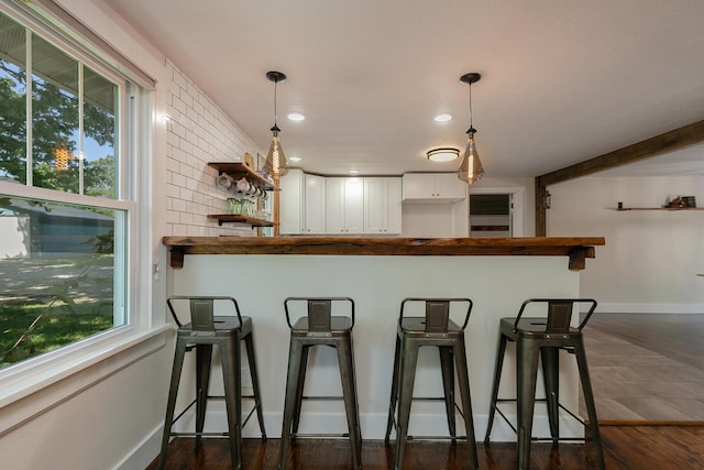 439 Union Chapel Rd, Fordland, MO 65652 - kitchen featuring white cabinetry, open shelves, a breakfast bar area, hanging light fixtures, and baseboards