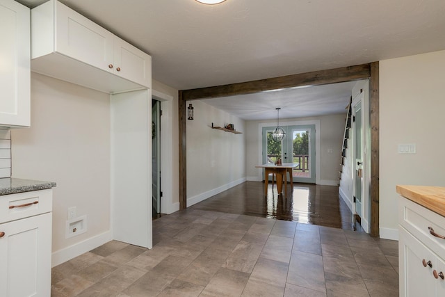 439 Union Chapel Rd, Fordland, MO 65652 - kitchen featuring baseboards, white cabinets, beam ceiling, and decorative light fixtures