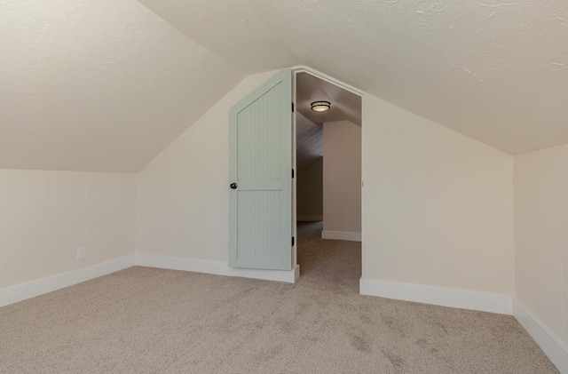 439 Union Chapel Rd, Fordland, MO 65652 - additional living space with carpet, vaulted ceiling, a textured ceiling, and baseboards