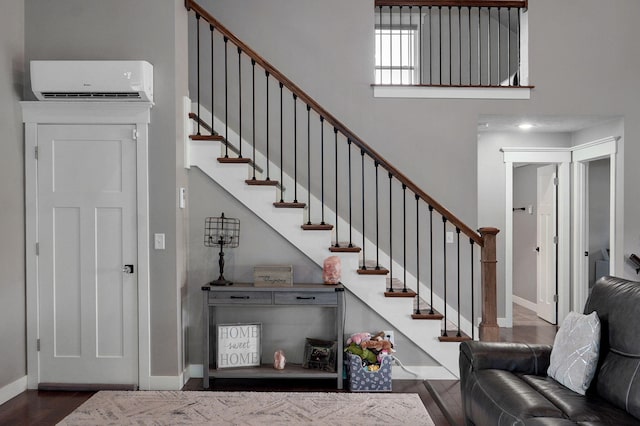 5116 S 165th Rd, Bolivar, MO 65613 - stairway with a wall mounted air conditioner, baseboards, wood finished floors, and a high ceiling
