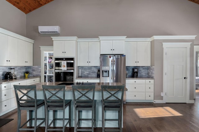 5116 S 165th Rd, Bolivar, MO 65613 - kitchen featuring a wall mounted AC, backsplash, high vaulted ceiling, stainless steel appliances, and white cabinetry