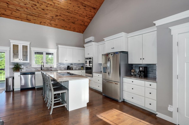 5116 S 165th Rd, Bolivar, MO 65613 - kitchen featuring stainless steel appliances, high vaulted ceiling, white cabinets, a kitchen bar, and decorative backsplash