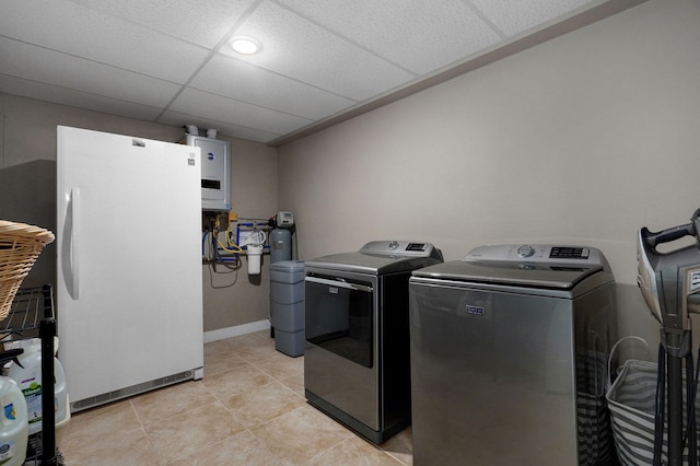 5116 S 165th Rd, Bolivar, MO 65613 - laundry room featuring washer and clothes dryer, light tile patterned flooring, recessed lighting, and water heater