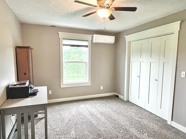 5116 S 165th Rd, Bolivar, MO 65613 - unfurnished bedroom featuring a wall mounted air conditioner, a textured ceiling, carpet flooring, baseboards, and a closet