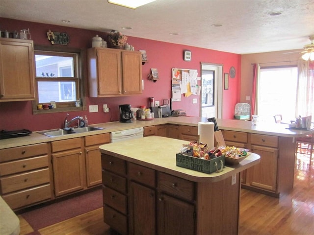 32880 Normal Dr, Eldridge, MO 65463 - kitchen with a sink, a peninsula, light countertops, and a kitchen island