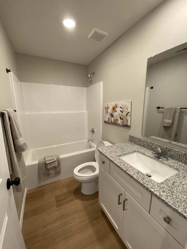 1221 Charlene Dr, Bolivar, MO 65613 - bathroom with wood finished floors, toilet, vanity, and washtub / shower combination