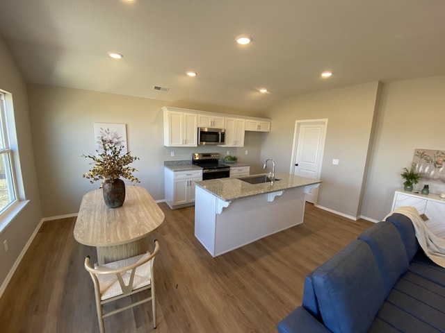 1221 Charlene Dr, Bolivar, MO 65613 - kitchen featuring appliances with stainless steel finishes, a sink, a center island with sink, white cabinetry, and dark wood-style flooring