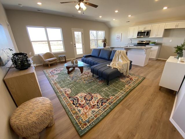 1221 Charlene Dr, Bolivar, MO 65613 - living room featuring a ceiling fan, light wood-style floors, baseboards, and recessed lighting