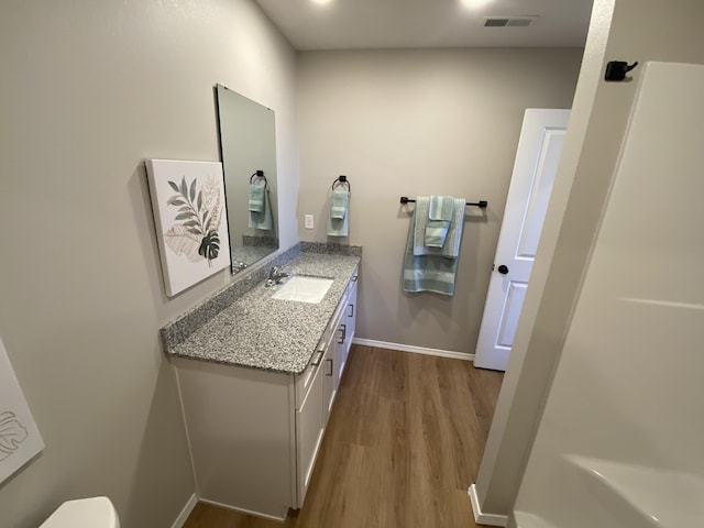 1221 Charlene Dr, Bolivar, MO 65613 - bathroom featuring wood finished floors, vanity, baseboards, and toilet