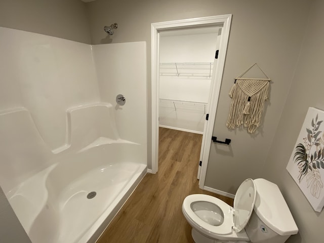 1221 Charlene Dr, Bolivar, MO 65613 - full bath with toilet, wood finished floors, a shower, a walk in closet, and baseboards