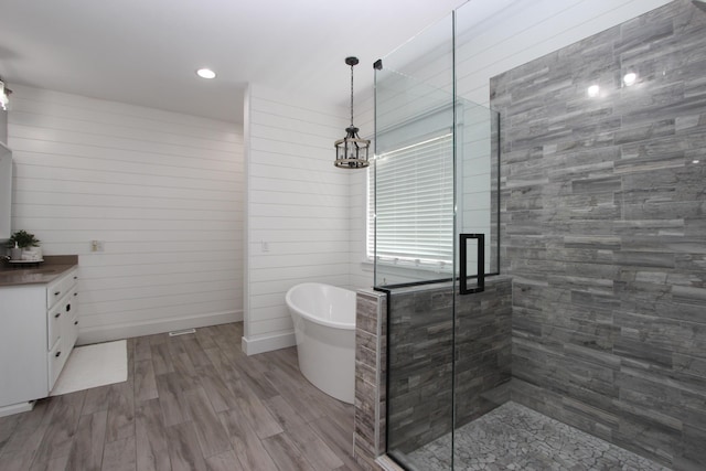 2362 Hazelwood Rd, Seymour, MO 65746 - bathroom featuring a freestanding bath, a stall shower, vanity, wood finished floors, and recessed lighting
