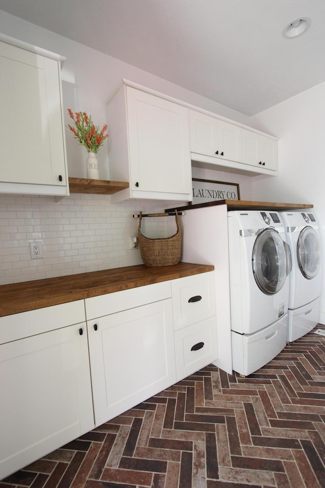 2362 Hazelwood Rd, Seymour, MO 65746 - washroom featuring washing machine and clothes dryer, cabinet space, and brick floors