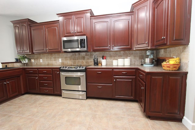2362 Hazelwood Rd, Seymour, MO 65746 - kitchen featuring appliances with stainless steel finishes, decorative backsplash, dark brown cabinets, and a sink