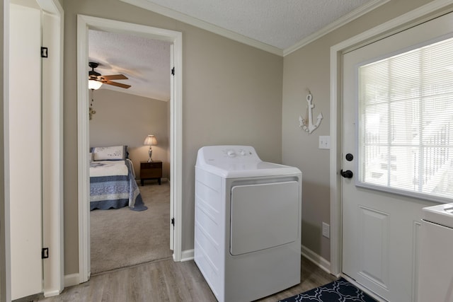 269 Moore Ln, Blue Eye, MO 65611 - laundry area with washer / dryer, a textured ceiling, light wood-type flooring, a ceiling fan, and crown molding