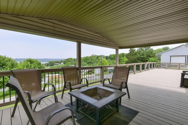 269 Moore Ln, Blue Eye, MO 65611 - wooden deck with an outdoor fire pit and an outbuilding