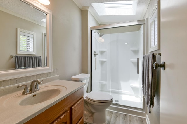 269 Moore Ln, Blue Eye, MO 65611 - full bathroom featuring a skylight, ornamental molding, a stall shower, vanity, and toilet