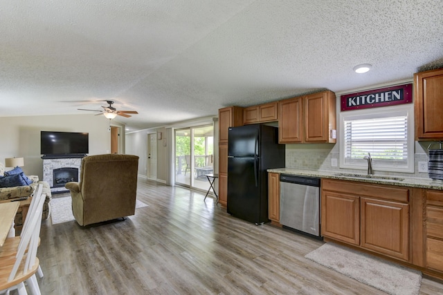 269 Moore Ln, Blue Eye, MO 65611 - kitchen featuring dishwasher, freestanding refrigerator, a sink, a textured ceiling, and light wood-style flooring