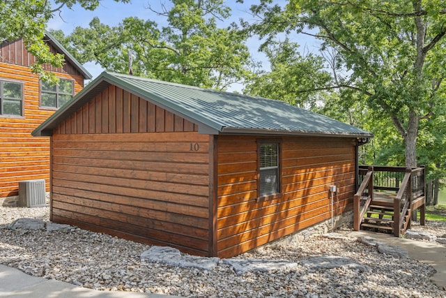 26 Cave Ln Unit 10, Indian Point, MO 65616 - view of side of home with metal roof, cooling unit, an outdoor structure, and board and batten siding
