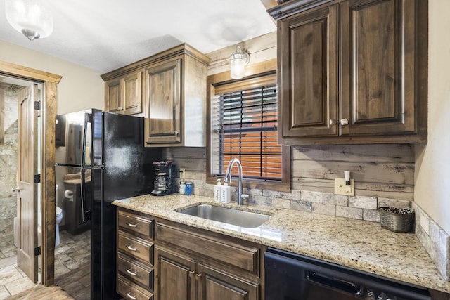 26 Cave Ln Unit 10, Indian Point, MO 65616 - kitchen with a sink, black appliances, light stone countertops, and dark brown cabinets