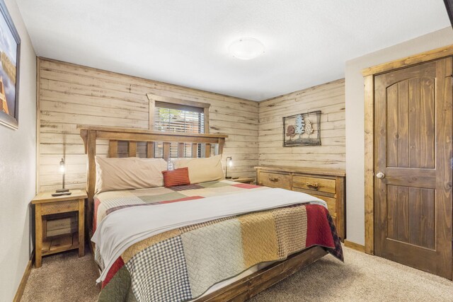 26 Cave Ln Unit 10, Indian Point, MO 65616 - bedroom with wooden walls, carpet floors, and baseboards