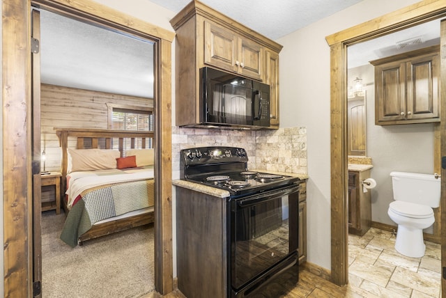 26 Cave Ln Unit 10, Indian Point, MO 65616 - kitchen featuring black appliances, baseboards, tasteful backsplash, and light stone finish flooring