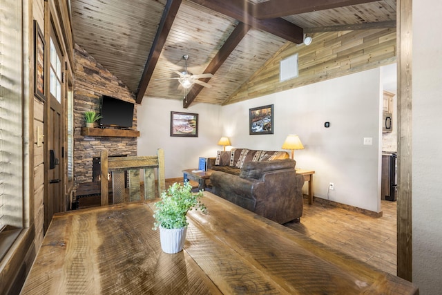 26 Cave Ln Unit 10, Indian Point, MO 65616 - dining area featuring ceiling fan, hardwood / wood-style floors, baseboards, a stone fireplace, and wooden ceiling with exposed beams
