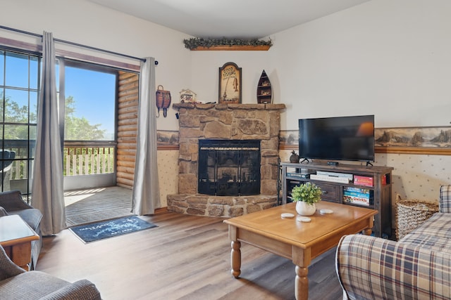 24 Village Trl Unit 13-2, Branson, MO 65616 - living room featuring wood finished floors and a stone fireplace