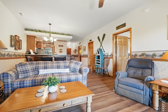24 Village Trl Unit 13-2, Branson, MO 65616 - living room with light wood-type flooring, a wainscoted wall, wallpapered walls, a chandelier, and ceiling fan
