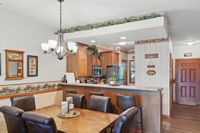24 Village Trl Unit 13-2, Branson, MO 65616 - dining area featuring wallpapered walls, a chandelier, dark wood-style floors, and recessed lighting
