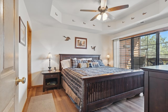 24 Village Trl Unit 13-2, Branson, MO 65616 - bedroom featuring a tray ceiling, wood finished floors, and baseboards